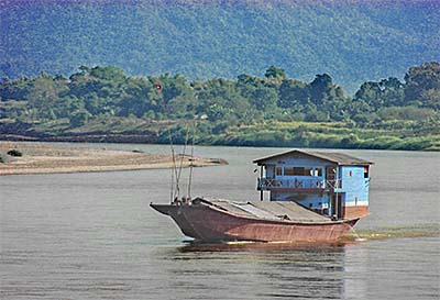 'A Wooden Laotian Transport Ship on the Mekong River at Chiang Khong' by Asienreisender